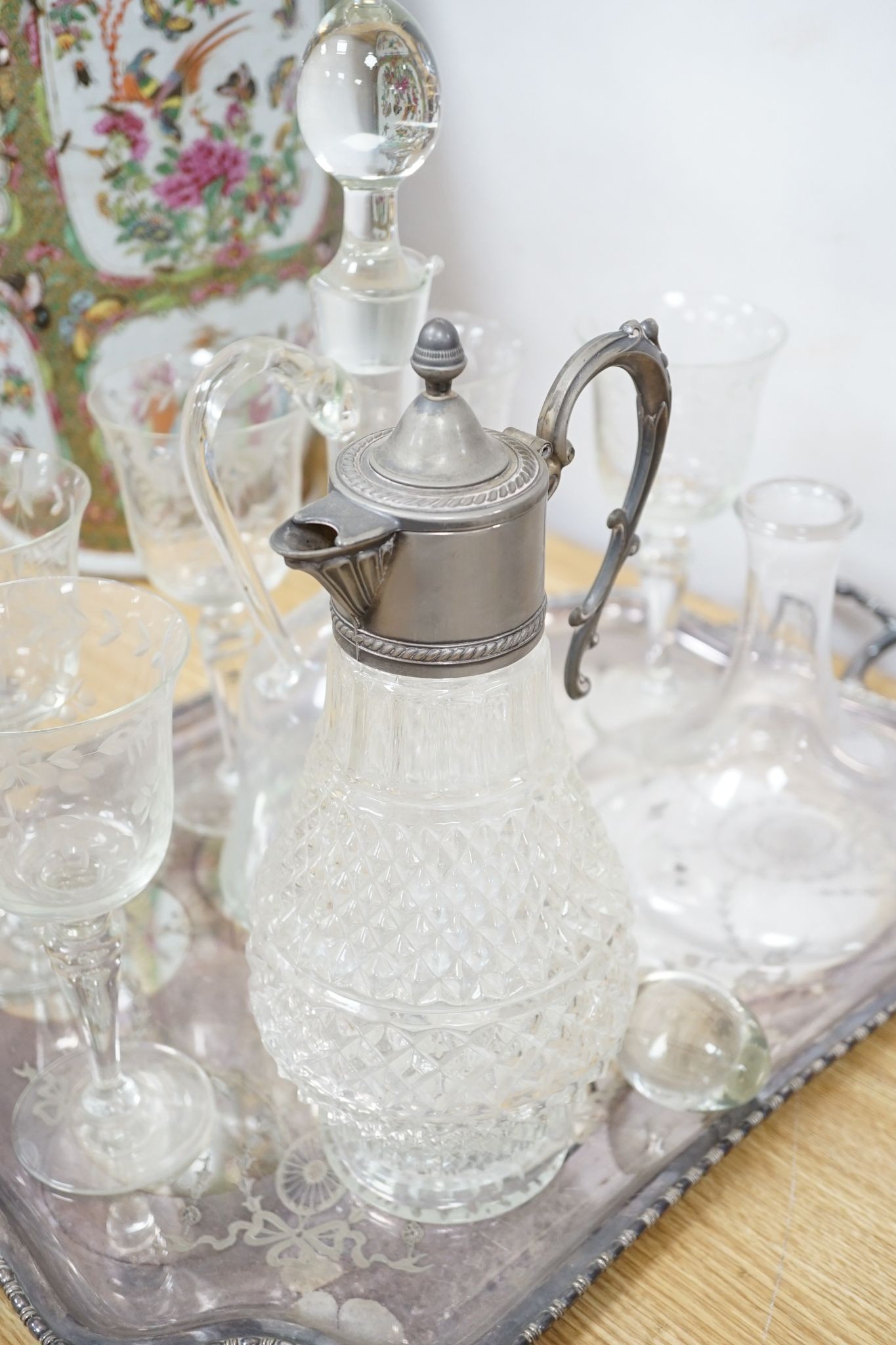 A plated two handled tea tray, a claret jug, two decanters and five glasses (9)